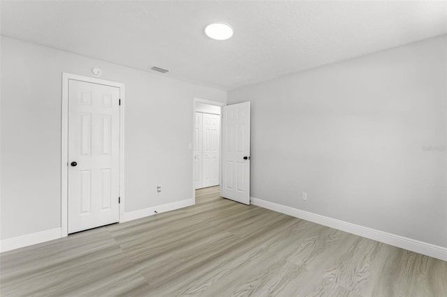 174 Pine Grove Ct, Daytona Beach, FL 32119 - unfurnished bedroom with baseboards and light wood finished floors