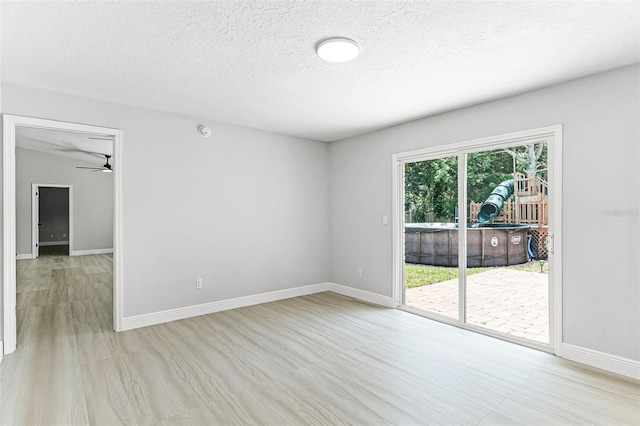 174 Pine Grove Ct, Daytona Beach, FL 32119 - unfurnished room featuring light wood finished floors, a textured ceiling, ceiling fan, and baseboards