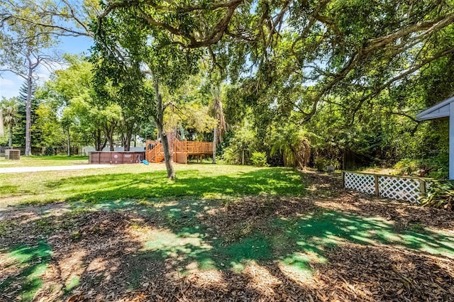 174 Pine Grove Ct, Daytona Beach, FL 32119 - view of grassy yard with a hot tub and view of wooded area