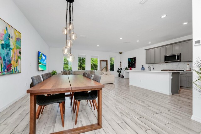 652 Benoi Dr, Davenport, FL 33896 - dining room featuring light wood-style floors, recessed lighting, and baseboards