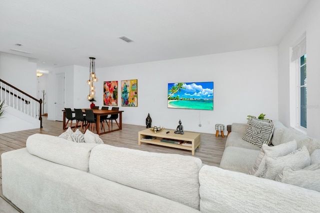 652 Benoi Dr, Davenport, FL 33896 - living room featuring stairs and light wood-style flooring