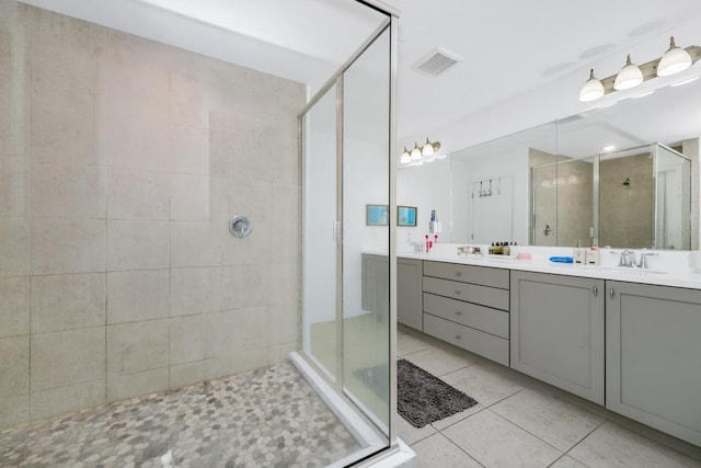 652 Benoi Dr, Davenport, FL 33896 - bathroom featuring a shower stall, double vanity, and tile patterned flooring