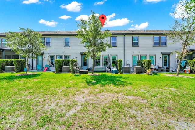 652 Benoi Dr, Davenport, FL 33896 - rear view of property with central AC and a lawn