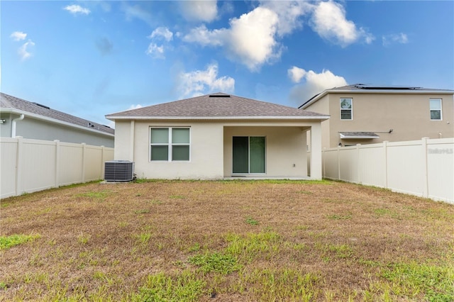 1267 Berry Ln, Davenport, FL 33837 - rear view of house featuring stucco siding, central air condition unit, and roof with shingles