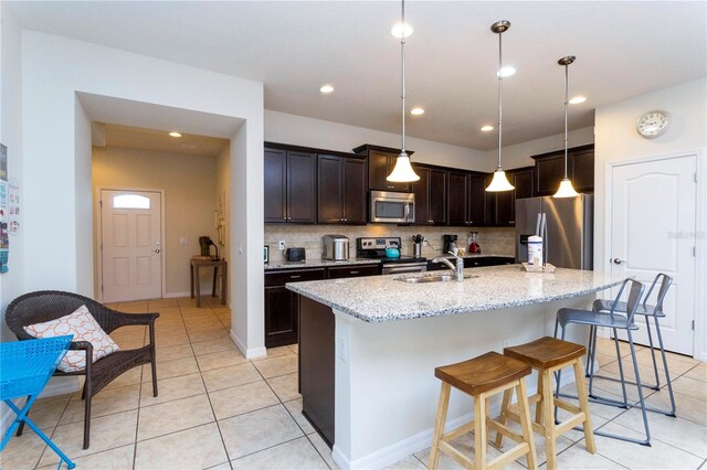 1979 Majorca Dr, Kissimmee, FL 34747 - kitchen featuring stainless steel appliances, a sink, backsplash, light tile patterned floors, and recessed lighting