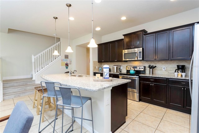 1979 Majorca Dr, Kissimmee, FL 34747 - kitchen with stainless steel appliances, a sink, tasteful backsplash, light tile patterned flooring, and recessed lighting