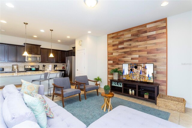 1979 Majorca Dr, Kissimmee, FL 34747 - living room featuring recessed lighting, light tile patterned flooring, and wood walls