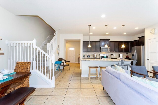 1979 Majorca Dr, Kissimmee, FL 34747 - living room with stairs, light tile patterned floors, and recessed lighting