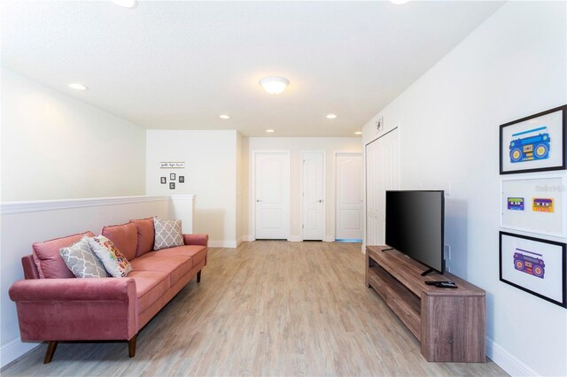 1979 Majorca Dr, Kissimmee, FL 34747 - living room featuring light wood-style floors, baseboards, and recessed lighting