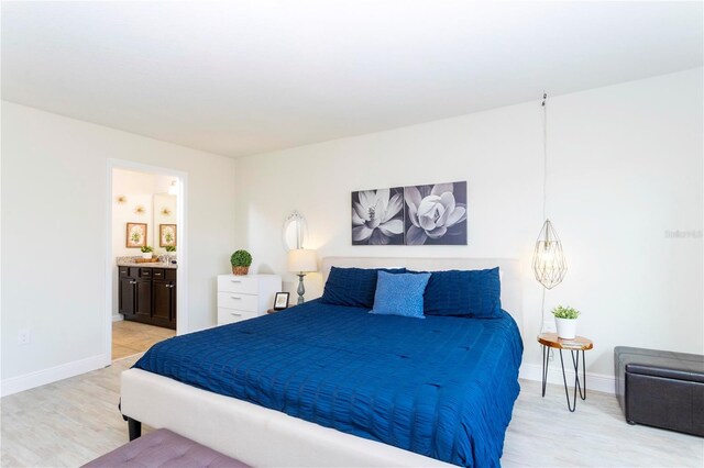 1979 Majorca Dr, Kissimmee, FL 34747 - bedroom featuring light wood-style flooring, baseboards, and ensuite bath
