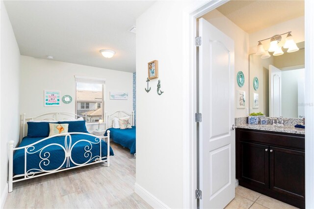 1979 Majorca Dr, Kissimmee, FL 34747 - bedroom featuring a sink and light wood finished floors