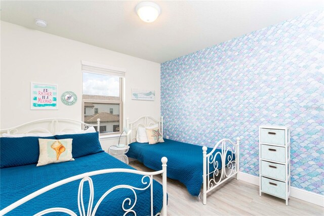 1979 Majorca Dr, Kissimmee, FL 34747 - bedroom featuring wallpapered walls, wood finished floors, and baseboards