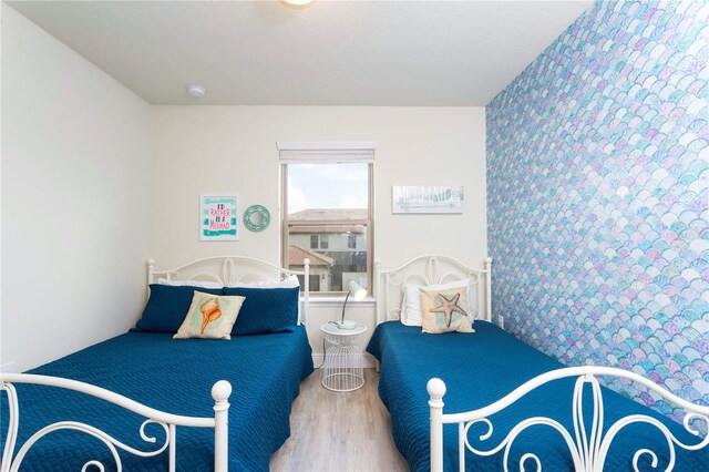 1979 Majorca Dr, Kissimmee, FL 34747 - bedroom featuring wood finished floors and wallpapered walls
