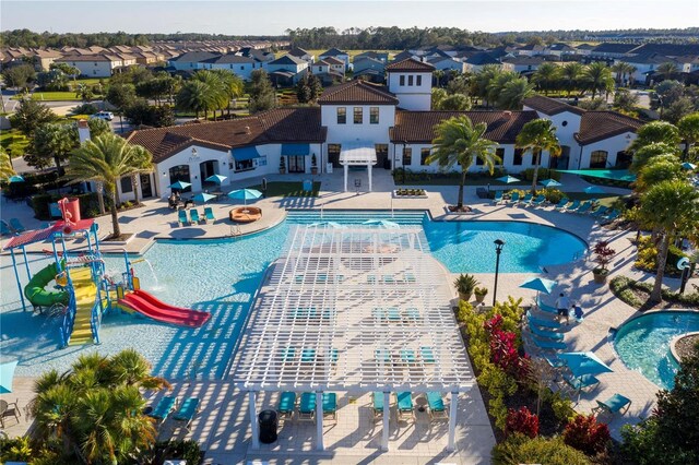 1979 Majorca Dr, Kissimmee, FL 34747 - community pool with a residential view, a water slide, a patio, and a water play area