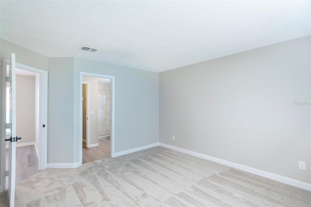 838 Haulover Dr, Altamonte Springs, FL 32714 - unfurnished bedroom featuring light carpet, baseboards, and connected bathroom