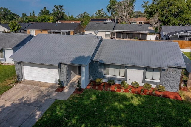 838 Haulover Dr, Altamonte Springs, FL 32714 - view of front of home featuring stone siding, a residential view, an attached garage, and metal roof