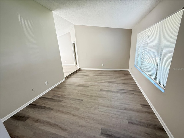 838 Haulover Dr, Altamonte Springs, FL 32714 - unfurnished room featuring lofted ceiling, wood finished floors, baseboards, and a textured ceiling