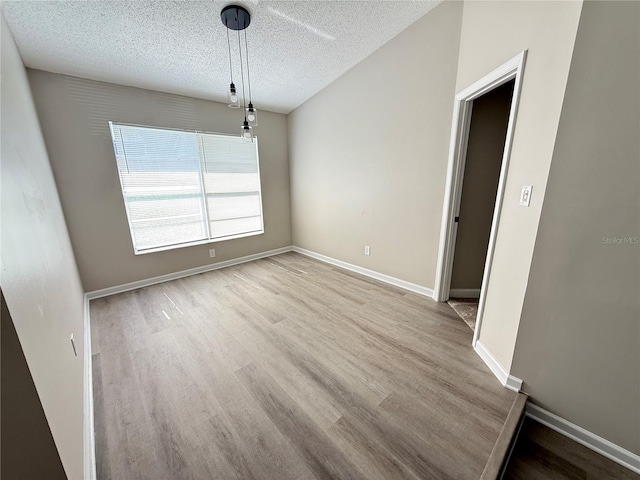 838 Haulover Dr, Altamonte Springs, FL 32714 - unfurnished dining area featuring wood finished floors, a textured ceiling, and baseboards