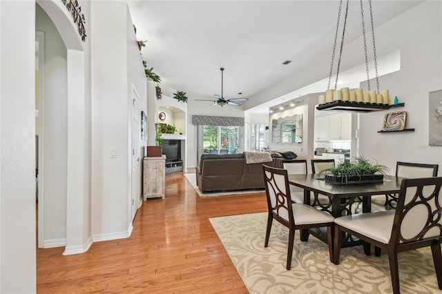 404 Sotheby Way, Debary, FL 32713 - dining room featuring light wood-style floors, ceiling fan, and arched walkways