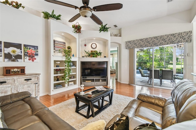 404 Sotheby Way, Debary, FL 32713 - living room with ceiling fan, wood finished floors, arched walkways, and baseboards
