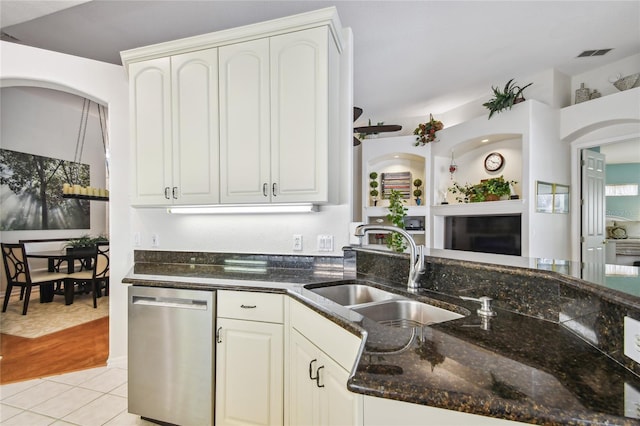 404 Sotheby Way, Debary, FL 32713 - kitchen featuring dishwasher, a sink, dark stone counters, light tile patterned flooring, and white cabinets