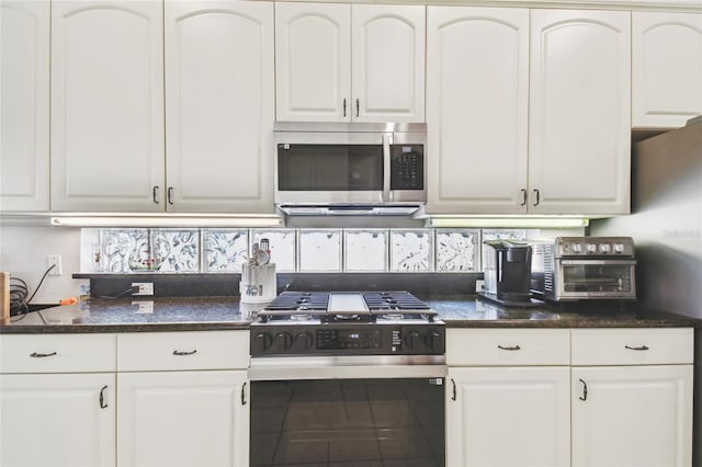 404 Sotheby Way, Debary, FL 32713 - kitchen with stainless steel microwave, range with gas stovetop, and white cabinets