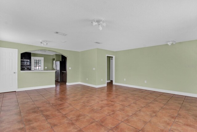416 Banyon Tree Cir Unit 108, Maitland, FL 32751 - unfurnished living room featuring arched walkways and baseboards
