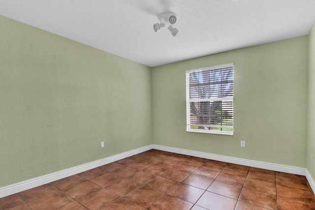 416 Banyon Tree Cir Unit 108, Maitland, FL 32751 - spare room featuring baseboards and dark tile patterned flooring