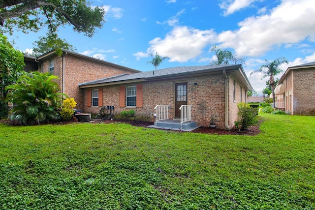 416 Banyon Tree Cir Unit 108, Maitland, FL 32751 - back of house with brick siding and a lawn