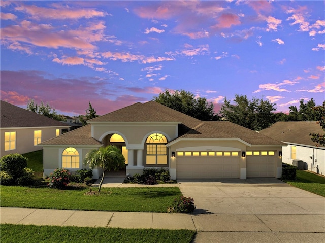 10955 Lemay Dr, Clermont, FL 34711 - mediterranean / spanish-style home featuring a garage, driveway, a front yard, and stucco siding