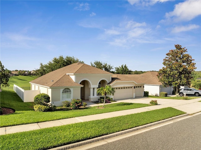 10955 Lemay Dr, Clermont, FL 34711 - mediterranean / spanish home with an attached garage, concrete driveway, stucco siding, and a shingled roof