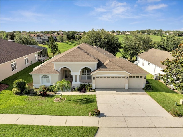 10955 Lemay Dr, Clermont, FL 34711 - mediterranean / spanish-style house featuring an attached garage, driveway, a front yard, stucco siding, and a residential view