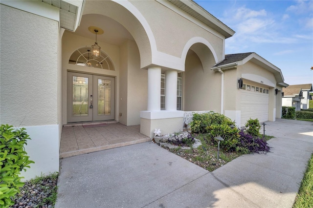 10955 Lemay Dr, Clermont, FL 34711 - entrance to property featuring french doors, stucco siding, a garage, and concrete driveway