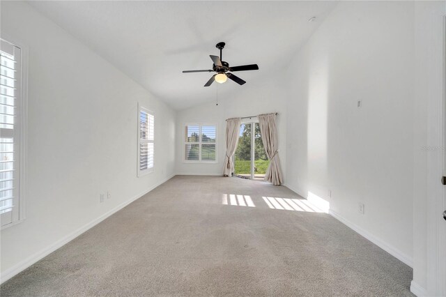 10955 Lemay Dr, Clermont, FL 34711 - spare room with light carpet, a ceiling fan, and vaulted ceiling