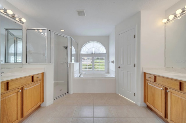 10955 Lemay Dr, Clermont, FL 34711 - full bathroom with two vanities, a bath, tile patterned flooring, and a stall shower