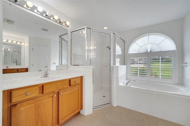 10955 Lemay Dr, Clermont, FL 34711 - full bathroom featuring vanity, healthy amount of natural light, tile patterned flooring, and a garden tub