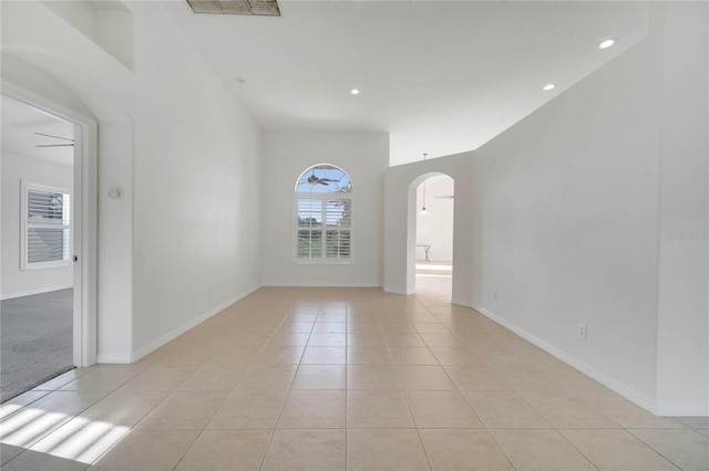 10955 Lemay Dr, Clermont, FL 34711 - spare room featuring arched walkways, light tile patterned floors, and recessed lighting