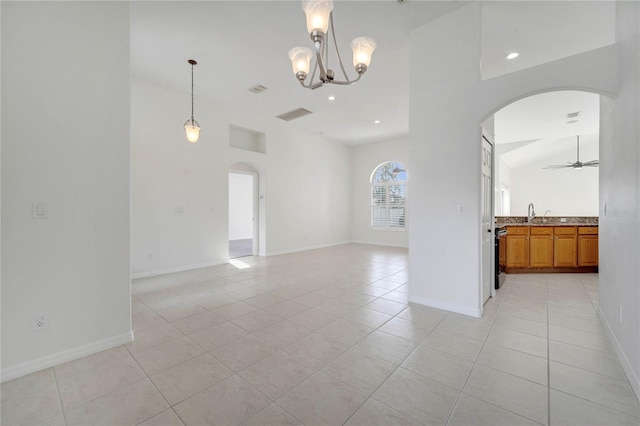 10955 Lemay Dr, Clermont, FL 34711 - empty room featuring arched walkways, light tile patterned floors, ceiling fan, a chandelier, and recessed lighting