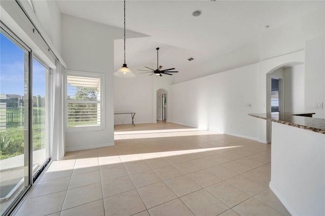 10955 Lemay Dr, Clermont, FL 34711 - spare room with arched walkways, high vaulted ceiling, light tile patterned floors, and ceiling fan