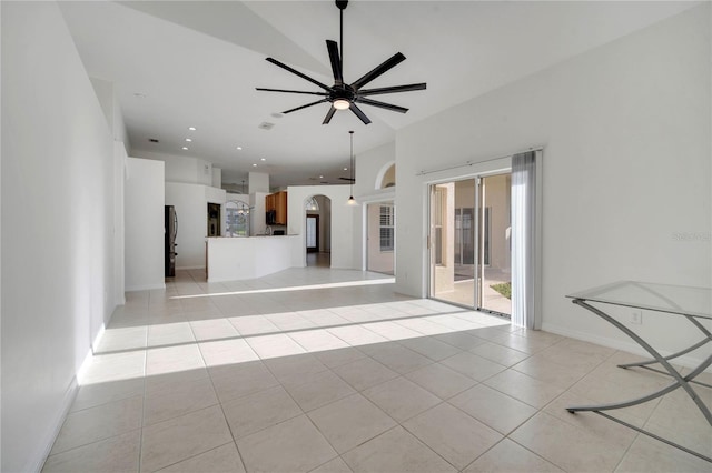 10955 Lemay Dr, Clermont, FL 34711 - unfurnished living room featuring light tile patterned floors, a ceiling fan, and arched walkways