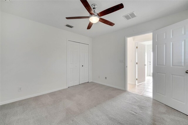 10955 Lemay Dr, Clermont, FL 34711 - unfurnished bedroom with light carpet, a closet, and ceiling fan