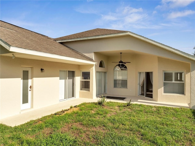 10955 Lemay Dr, Clermont, FL 34711 - back of house featuring ceiling fan, a lawn, stucco siding, a patio area, and a shingled roof