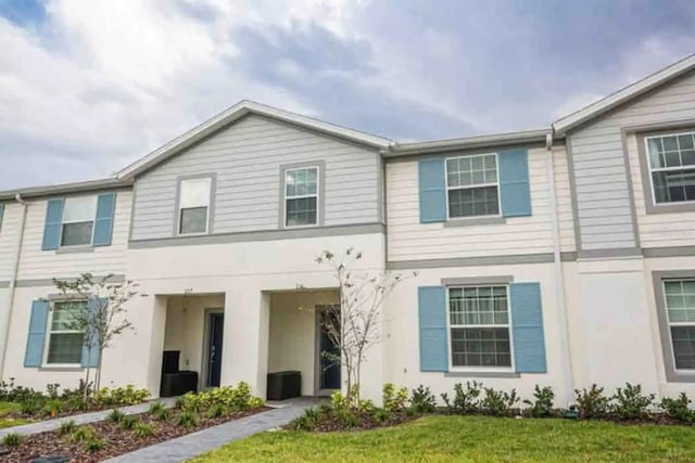 271 Jetty Way, Davenport, FL 33897 - townhome / multi-family property featuring stucco siding and a front yard