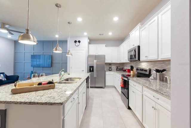 271 Jetty Way, Davenport, FL 33897 - kitchen featuring stainless steel appliances, a sink, white cabinets, tasteful backsplash, and recessed lighting