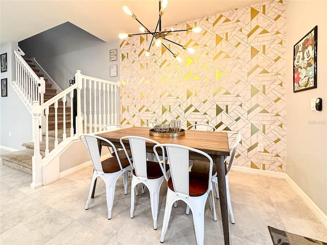 271 Jetty Way, Davenport, FL 33897 - dining area featuring an accent wall, baseboards, stairway, and a chandelier