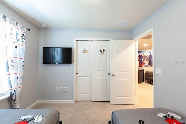 271 Jetty Way, Davenport, FL 33897 - bedroom with light colored carpet, a closet, and baseboards