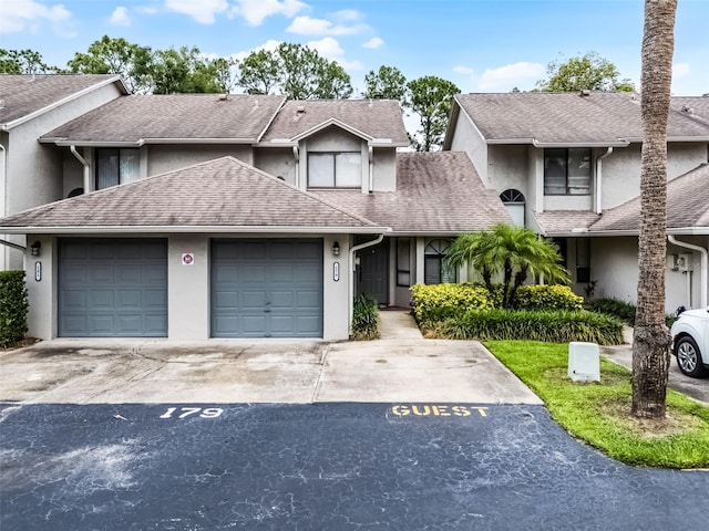 179 Crown Point Cir, Longwood, FL 32779 - townhome / multi-family property featuring stucco siding, concrete driveway, and a shingled roof