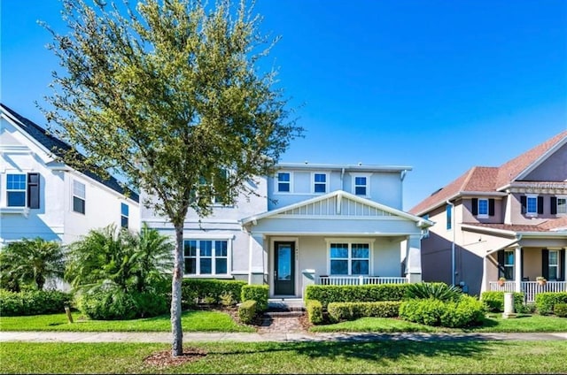 14753 Snowy Egret St, Winter Garden, FL 34787 - view of front of property with covered porch, stucco siding, and a front yard
