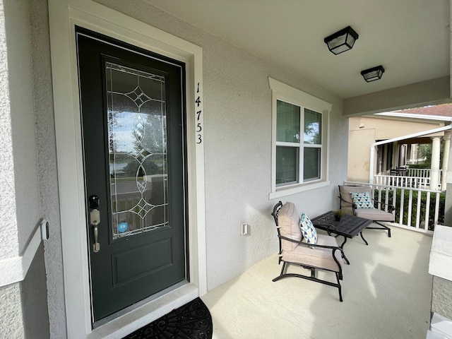 14753 Snowy Egret St, Winter Garden, FL 34787 - doorway to property with covered porch and stucco siding