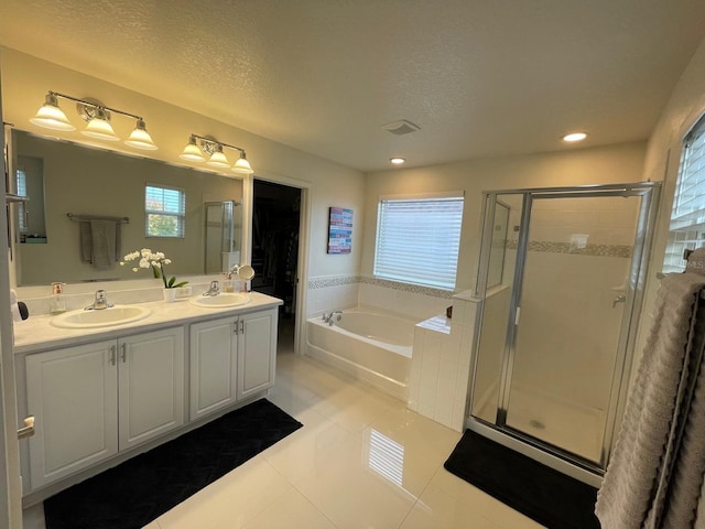 14753 Snowy Egret St, Winter Garden, FL 34787 - bathroom featuring a garden tub, healthy amount of natural light, a shower stall, a textured ceiling, and recessed lighting